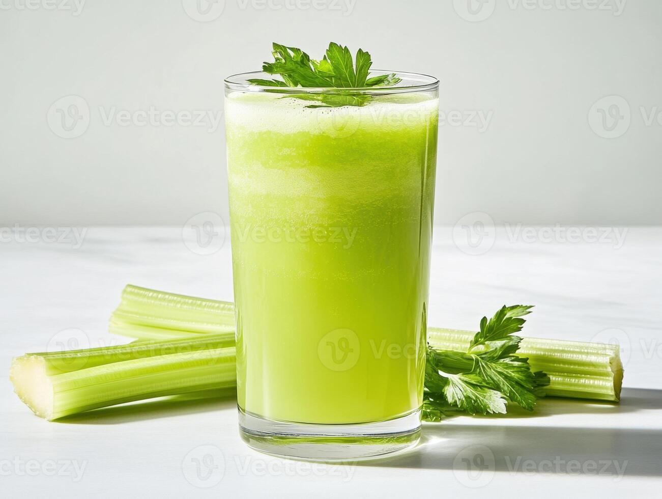 Refreshing green juice made from fresh celery stalks photo