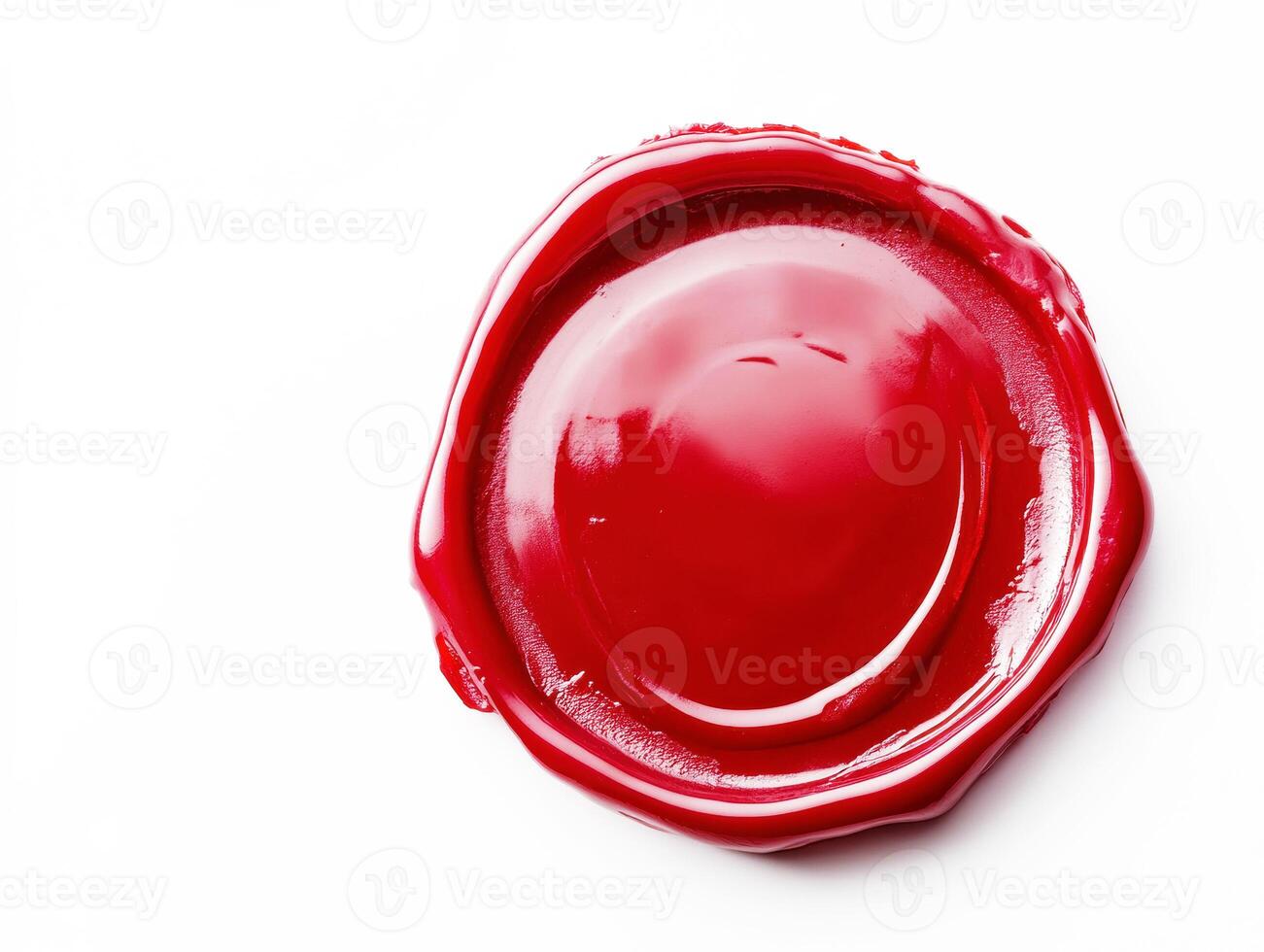 Red wax seal resting on a white surface in natural light photo