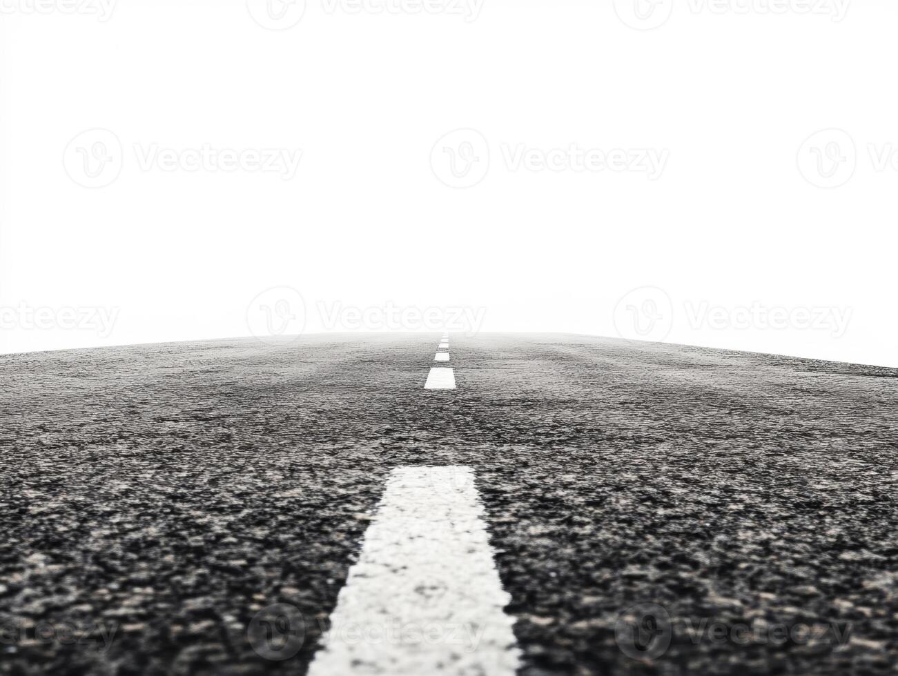 Open road stretching into the horizon on a foggy day photo