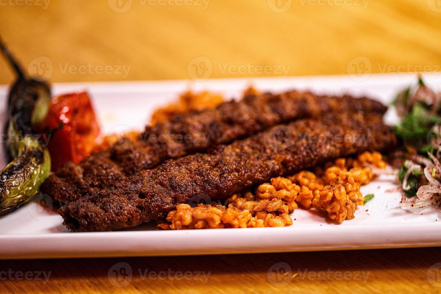 A plate with meat and rice on it photo