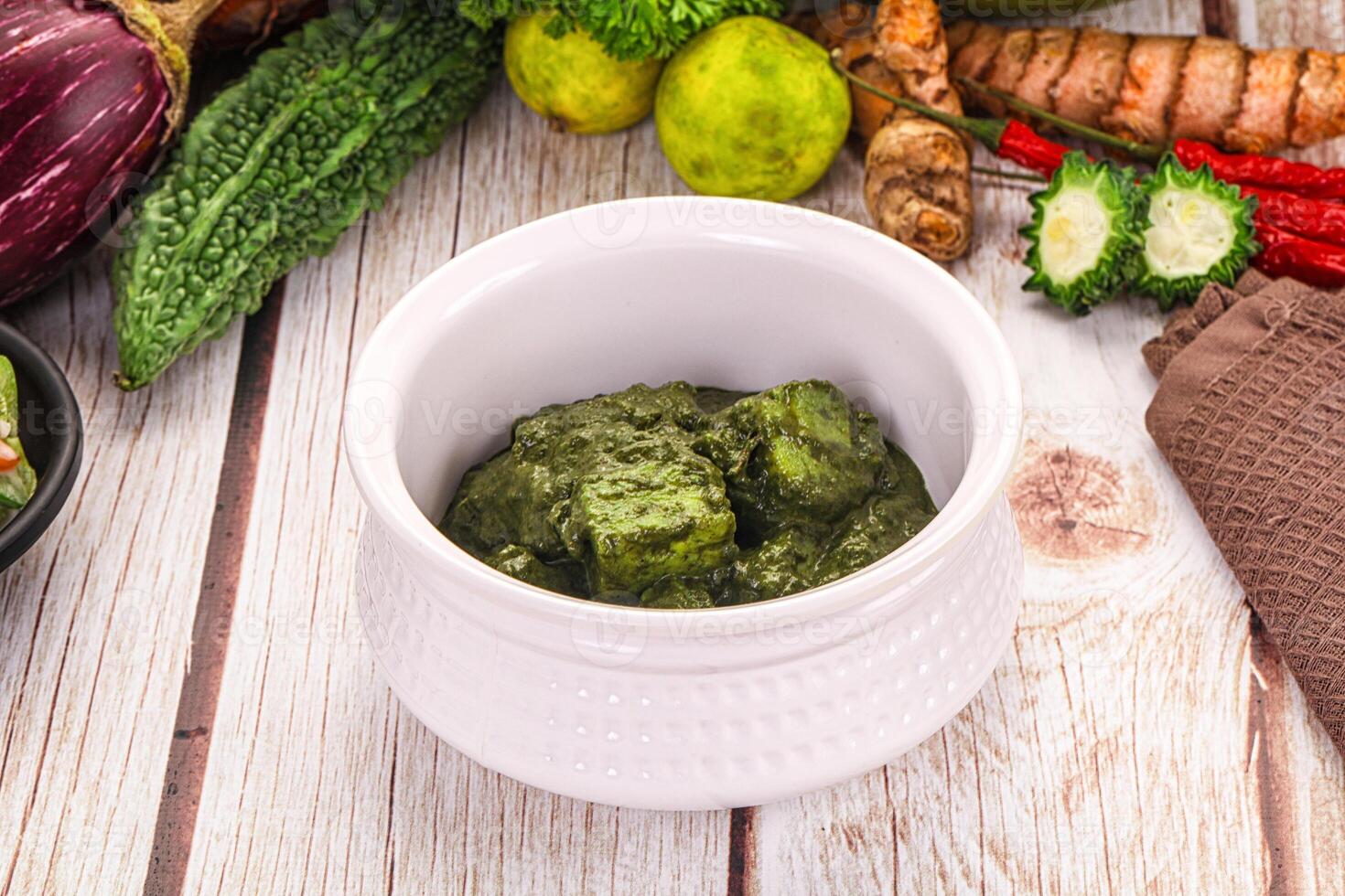 A bowl of green food on a table photo