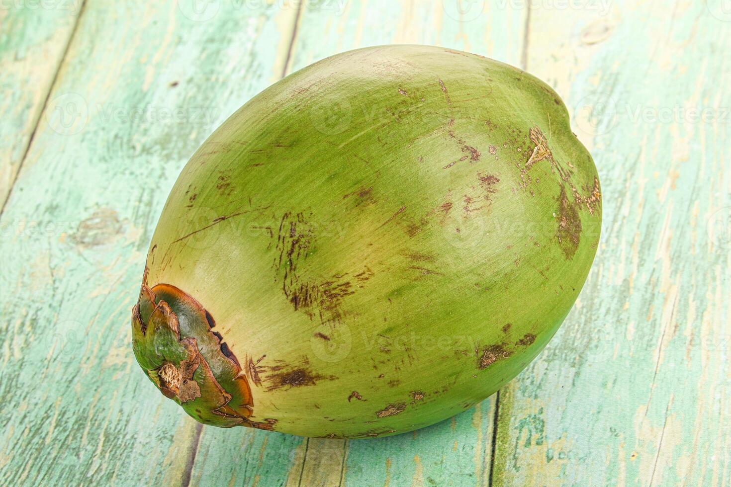 A coconut on a wooden table photo