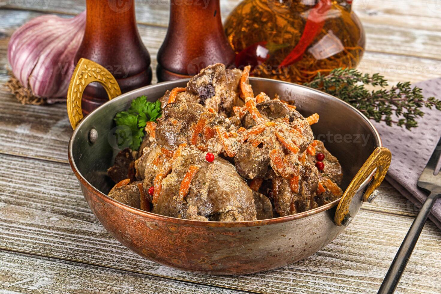 A bowl of meat and vegetables on a table photo