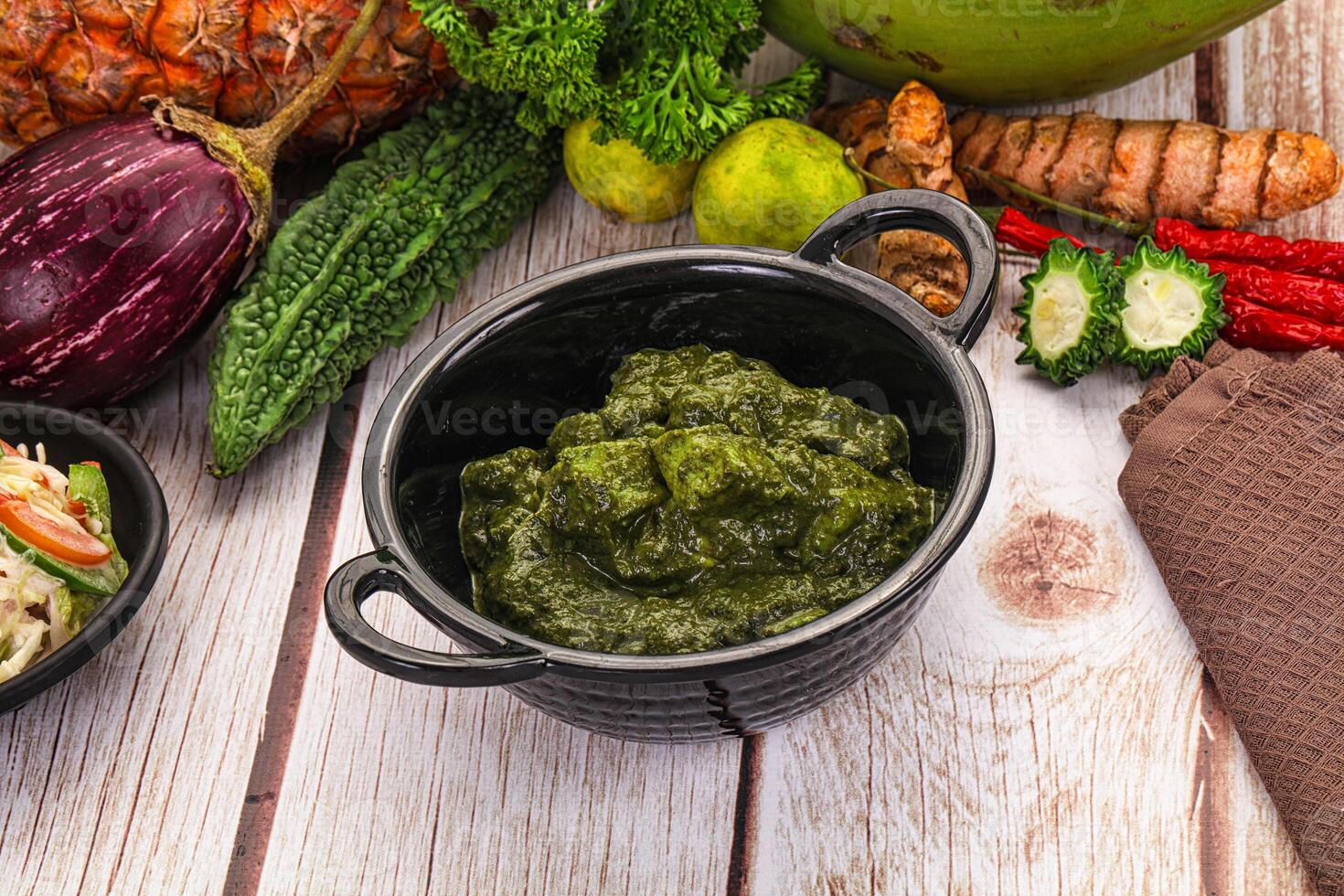 A table with a bowl of food and a bowl of vegetables photo