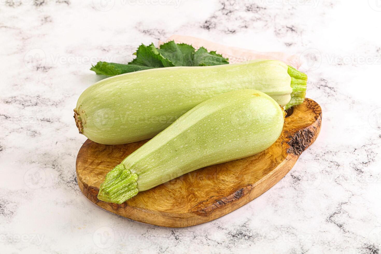 Two zucchini on a wooden cutting board photo