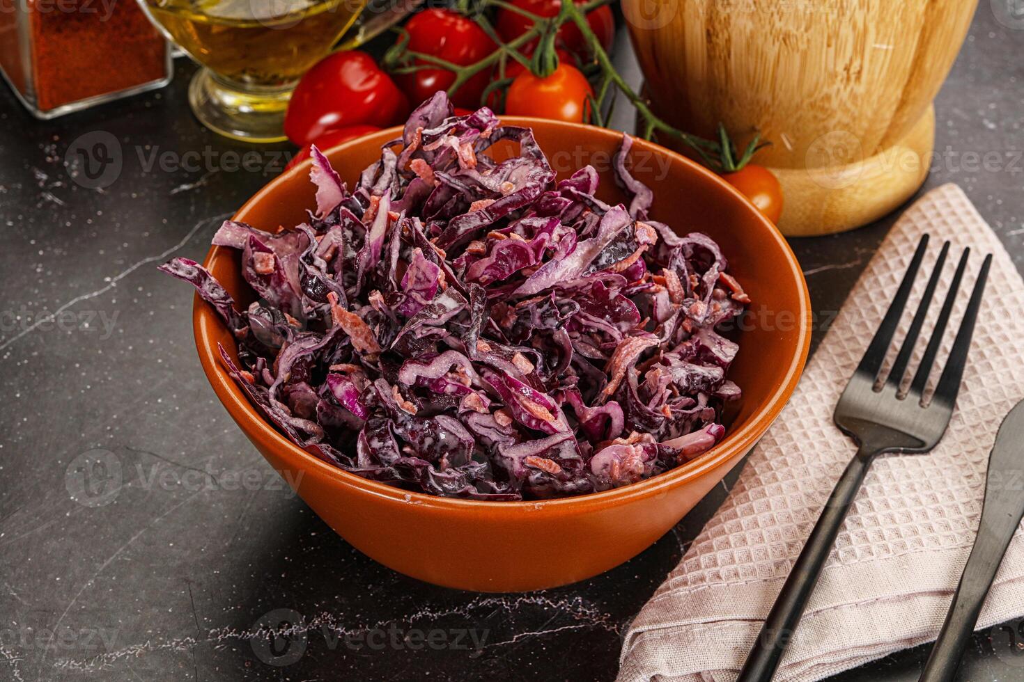 A bowl of red cabbage with a fork and knife photo