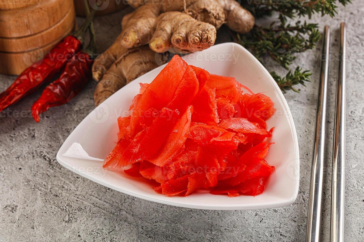 A bowl of red sliced cucumbers and ginger photo