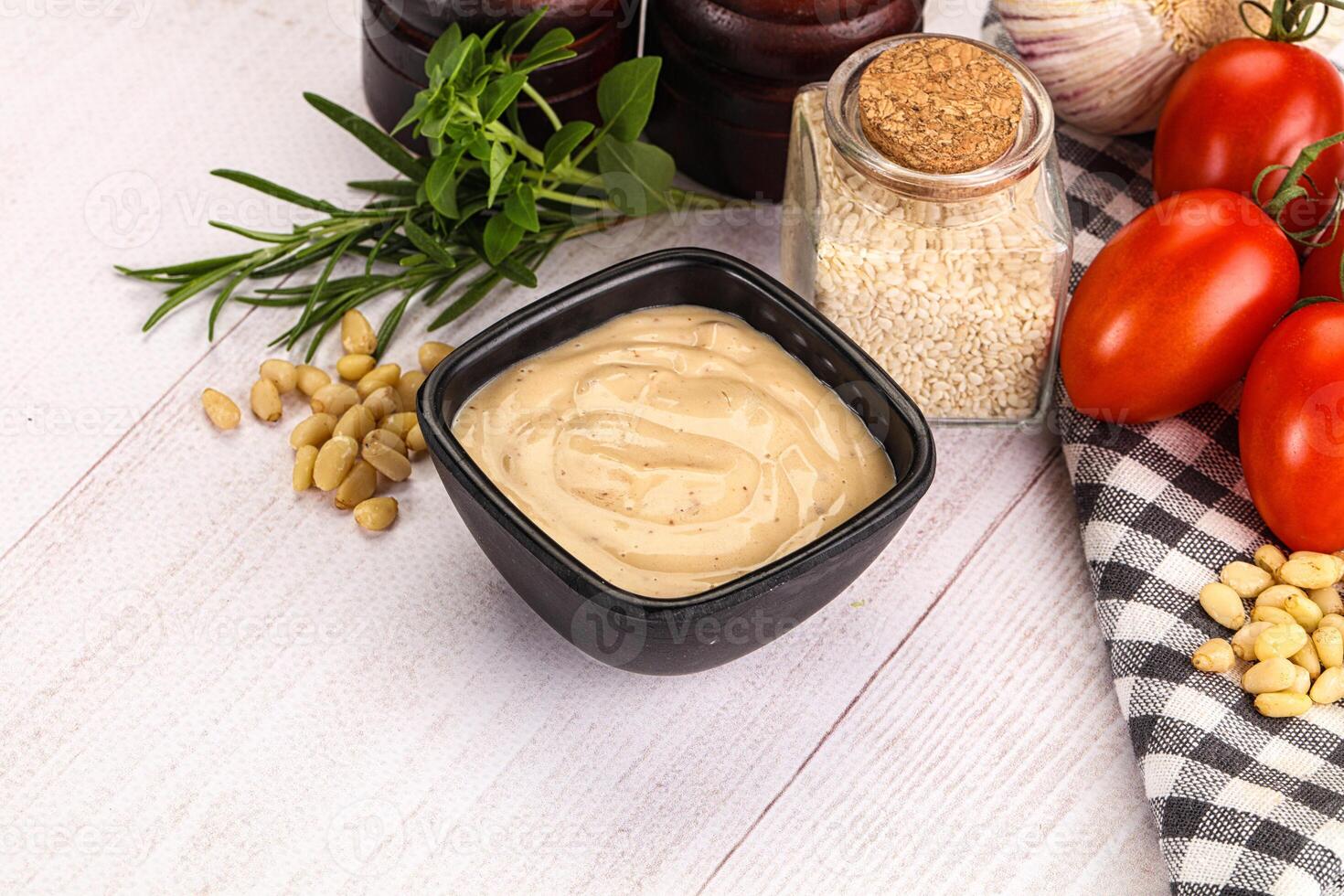 A bowl of peanut butter with tomatoes, garlic and other ingredients photo