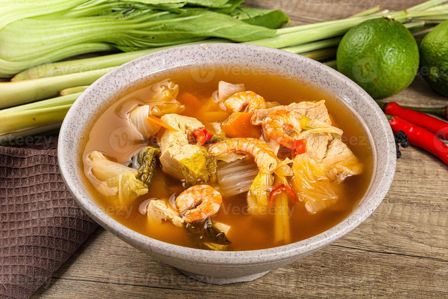 A bowl of soup with vegetables and shrimp photo