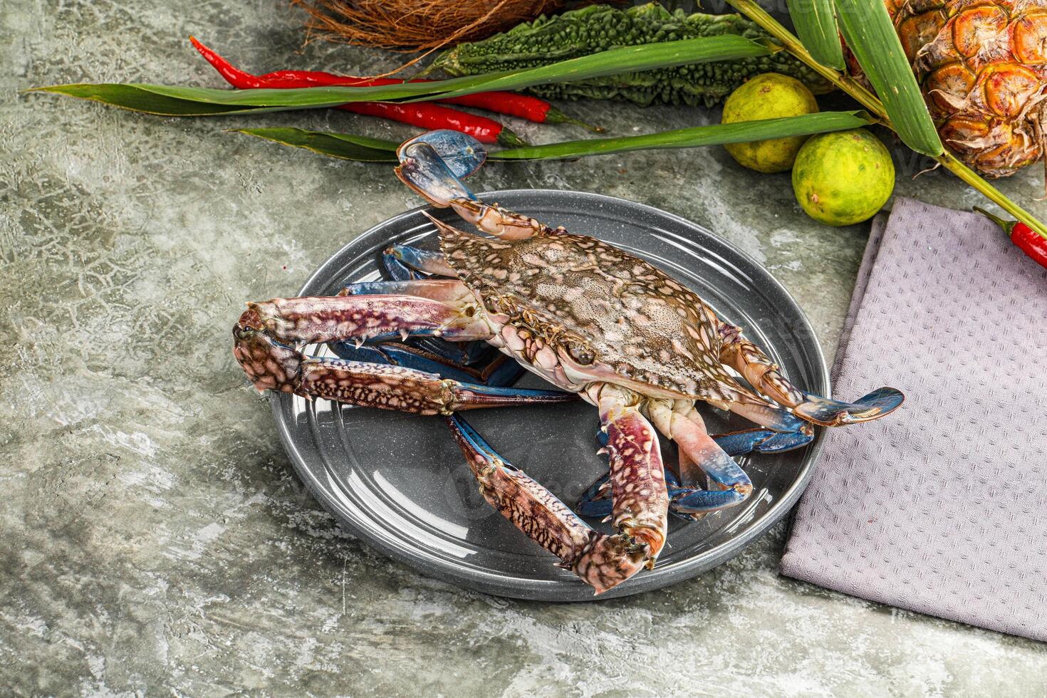 A crab on a plate with other food photo