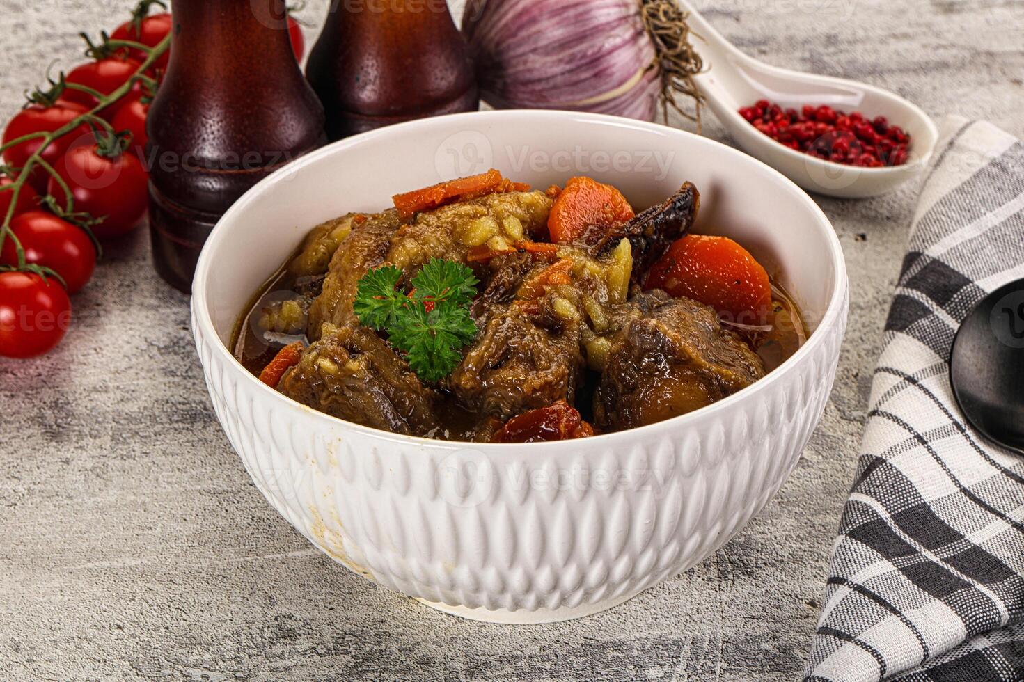 A bowl of stew with vegetables and meat in it photo