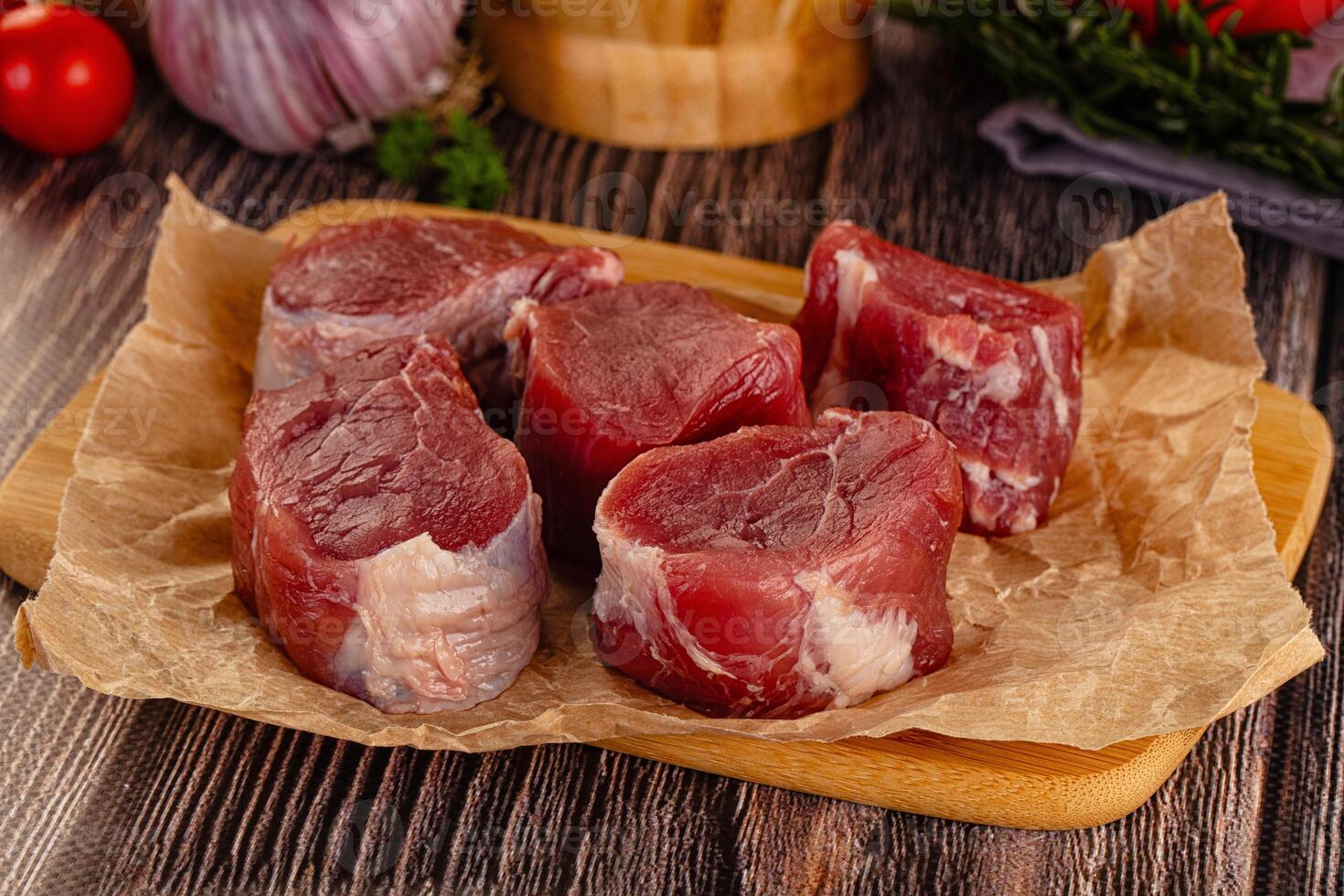Raw meat on a wooden cutting board photo