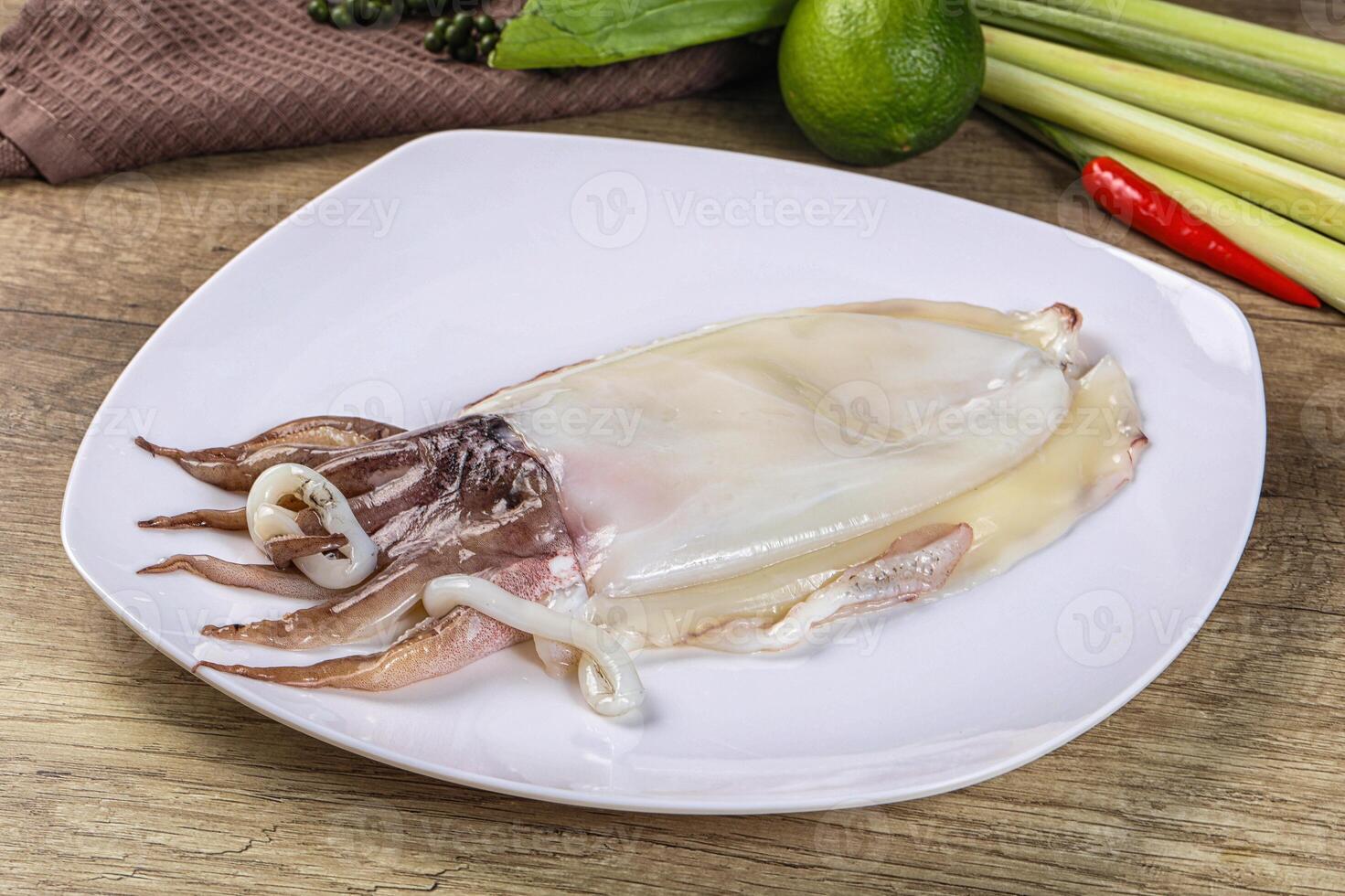A plate with a squid on it and some vegetables photo