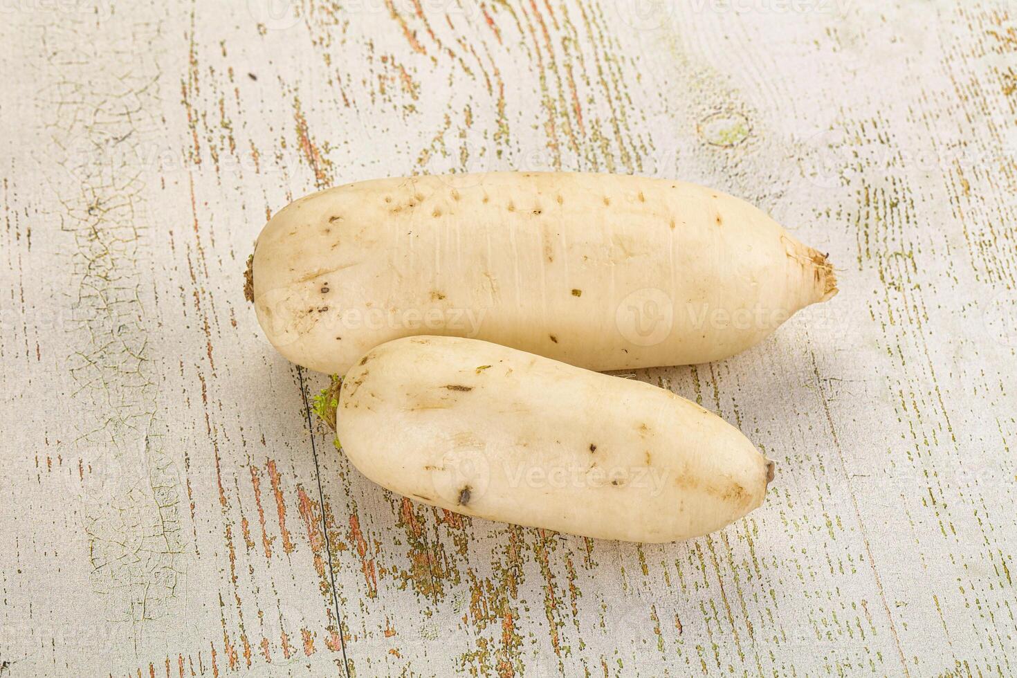 Two white potatoes on a wooden surface photo