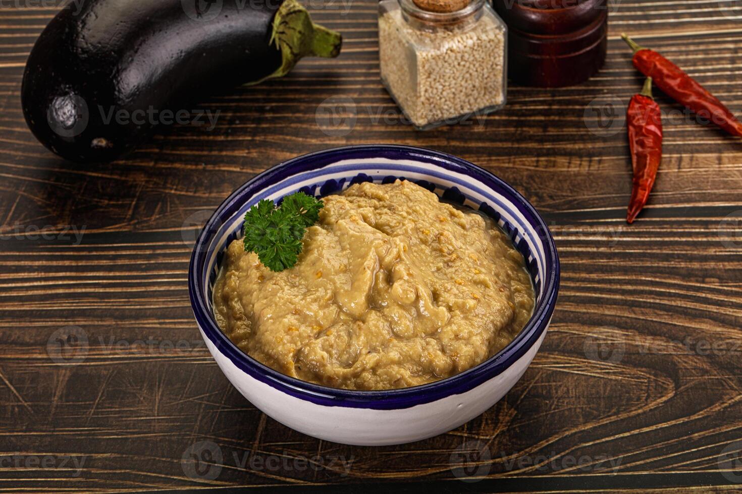 A bowl of hummus with a pepper and some spices photo