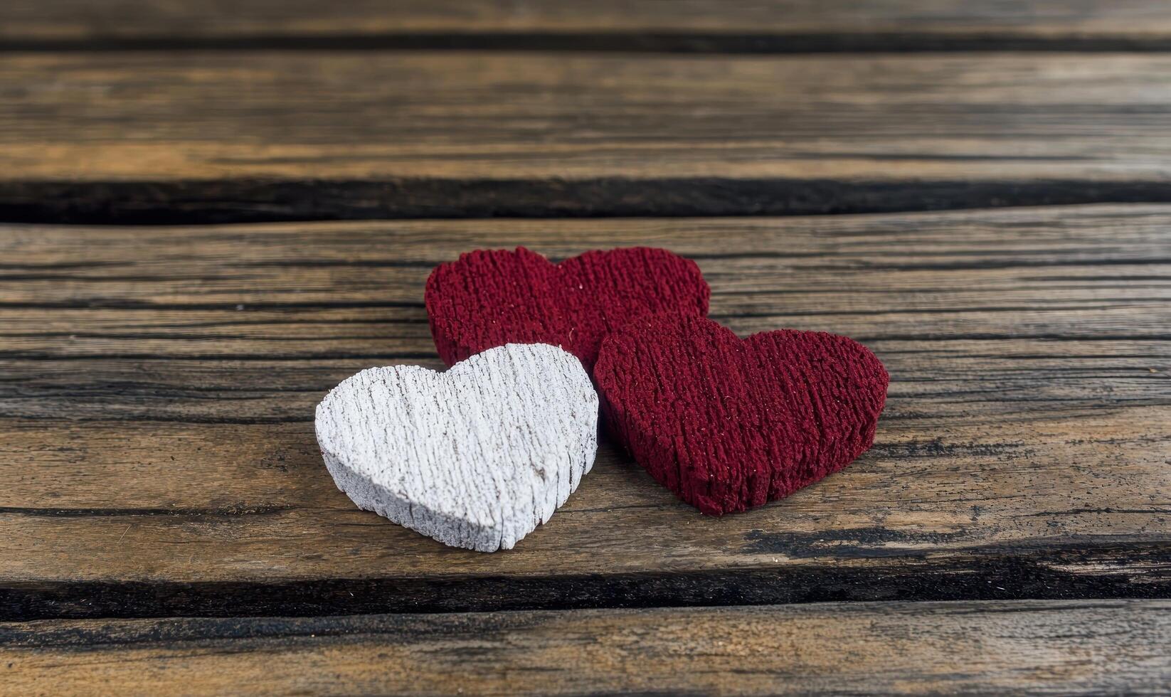 Three decorative hearts on a wooden surface photo