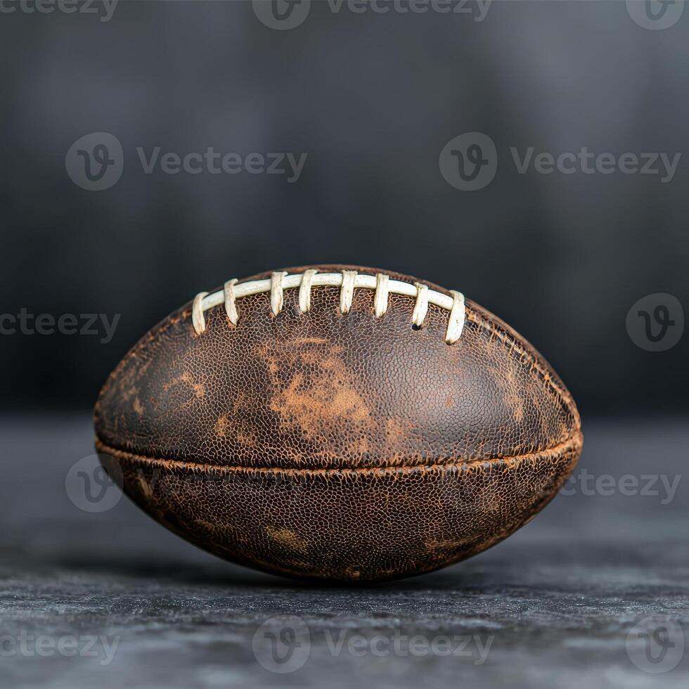 A vintage leather football on a dark background photo