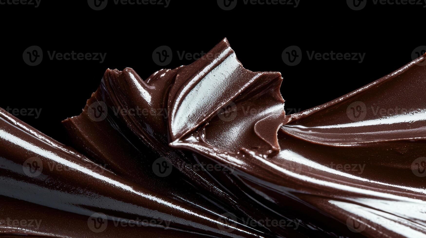 Close up of glossy dark chocolate swirl on black background photo