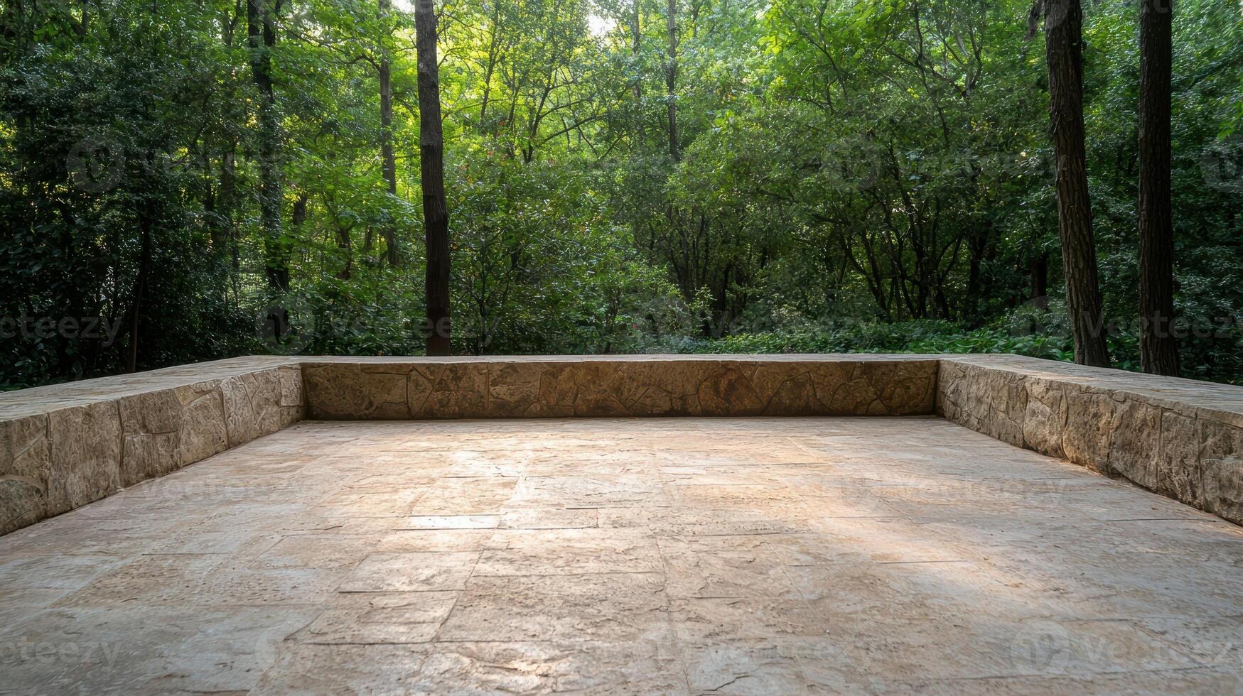 Stone patio overlooking a lush green forest photo