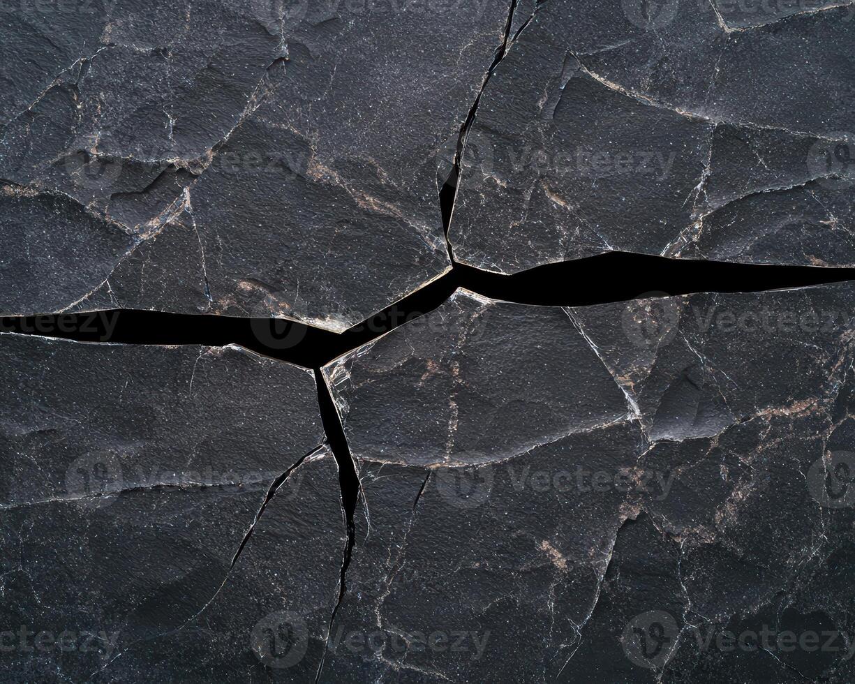 Cracked dark stone surface texture background photo