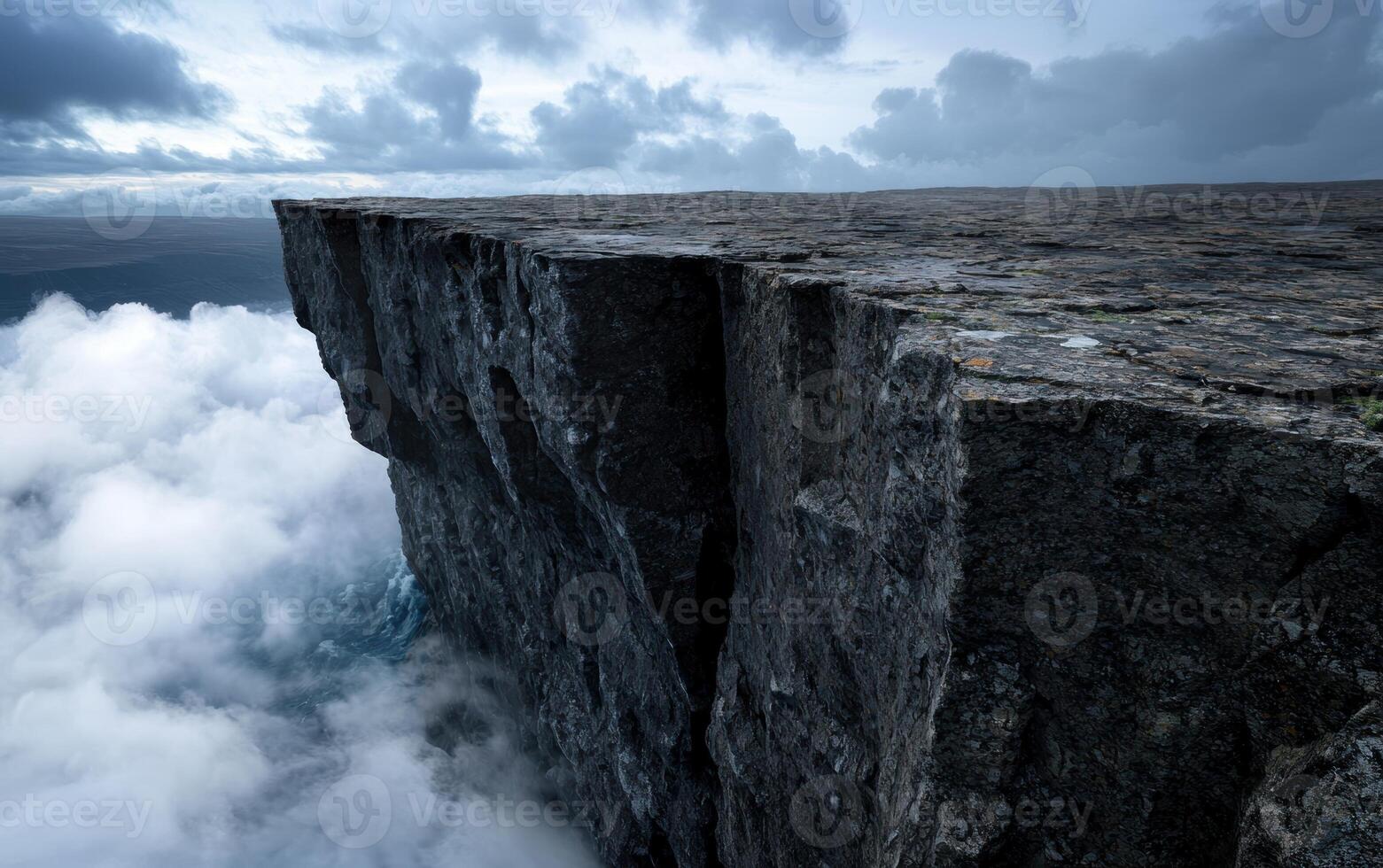 Dramatic cliff edge with clouds, ocean, and sky photo