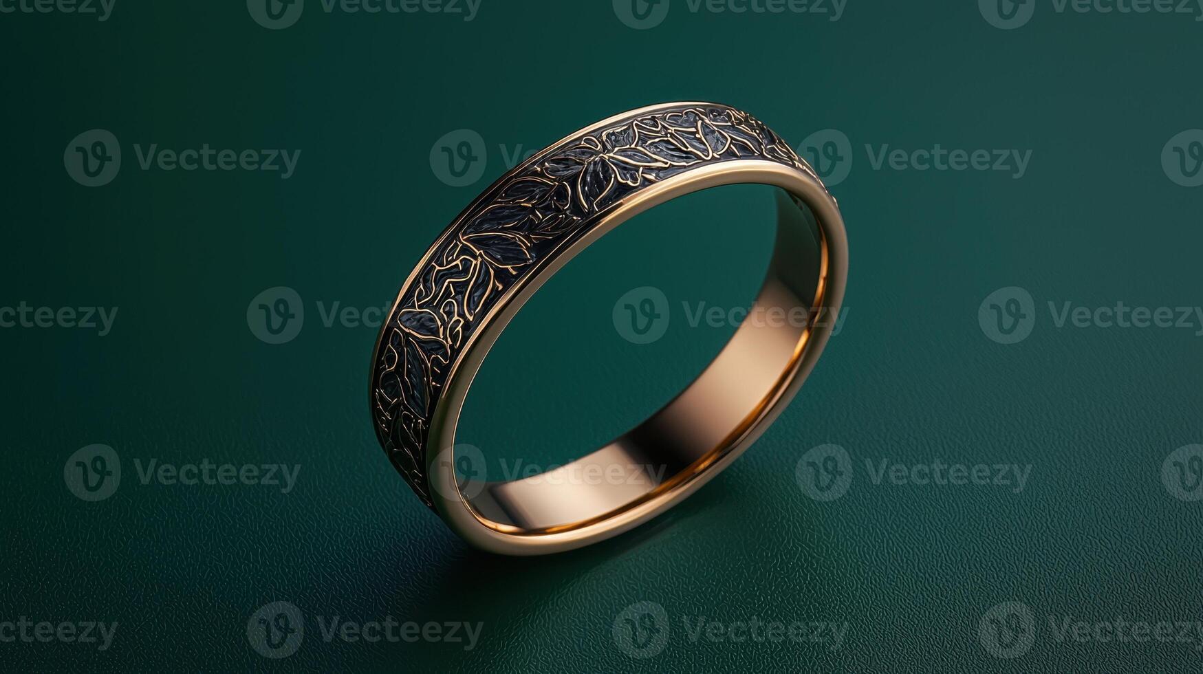 Gold ring with leaf pattern on green background photo