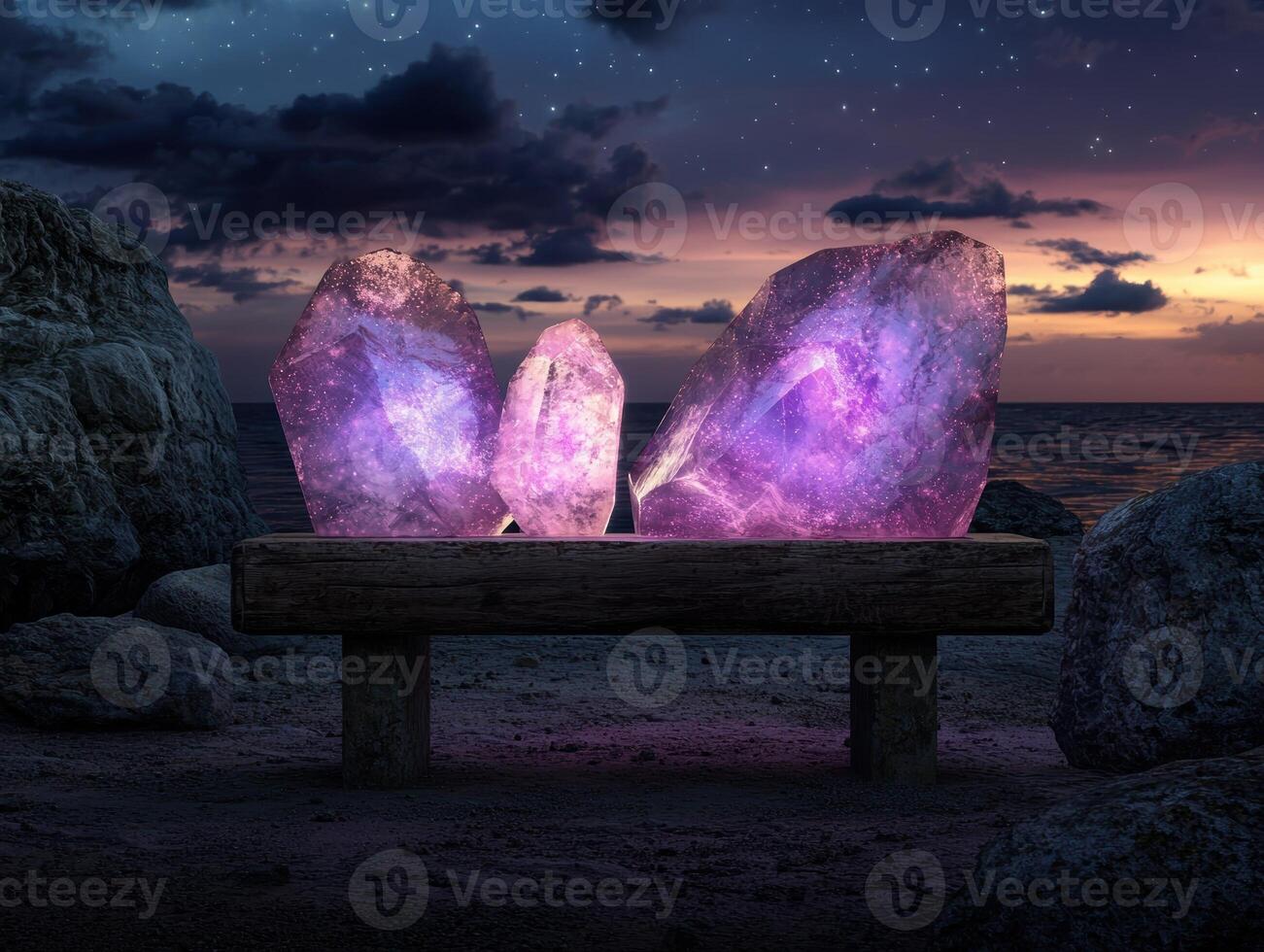 Three glowing amethyst crystals sit on a wooden bench on a beach at sunset photo
