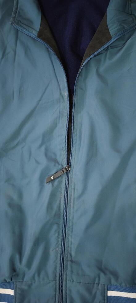 Teal Jacket with Half-Open Zipper Revealing Dark Inner Layer photo