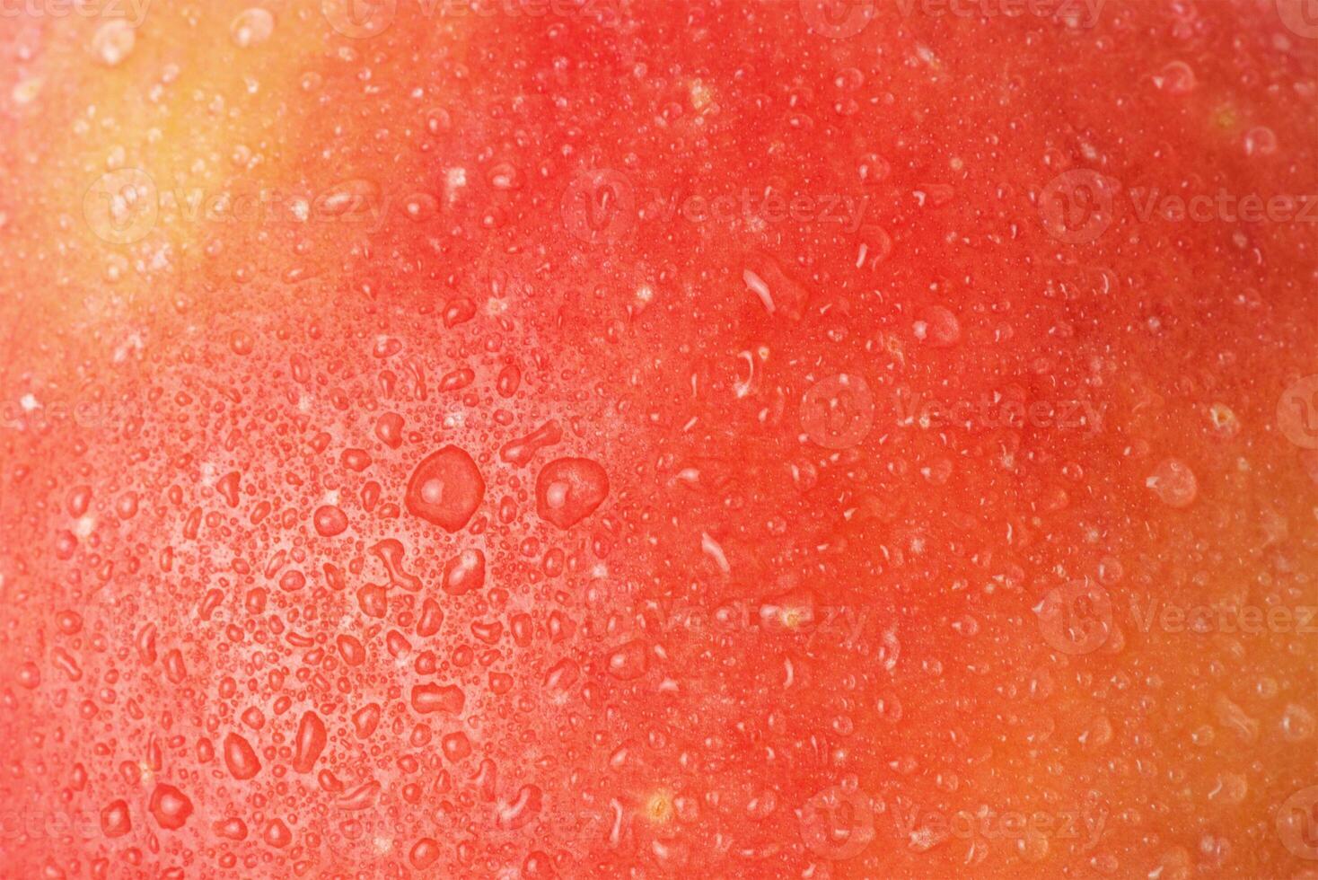 Red and yellow apples with water drops macro photo as a background.