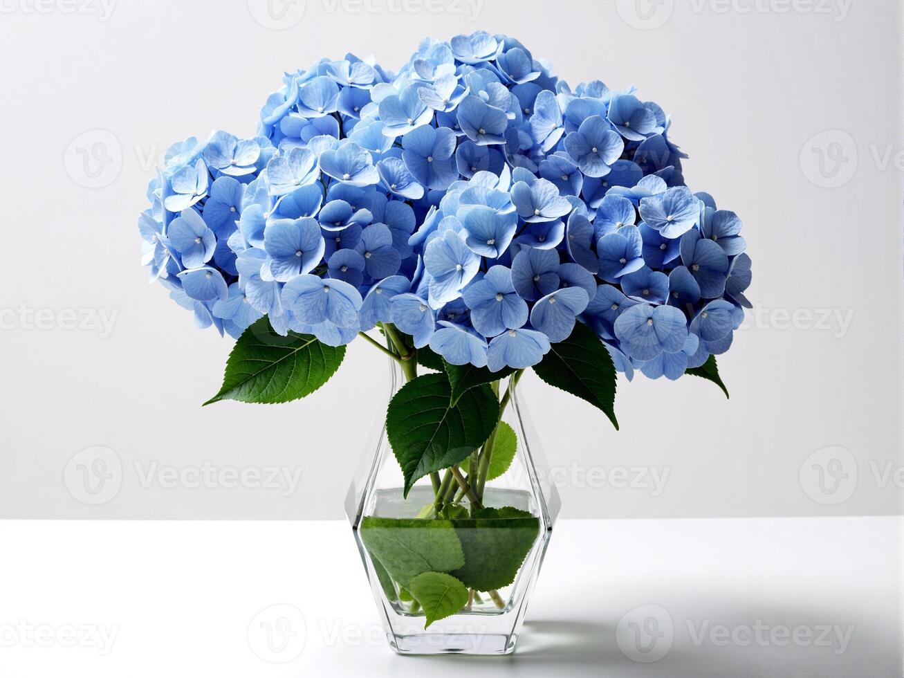 A vase filled with blue flowers on a table photo