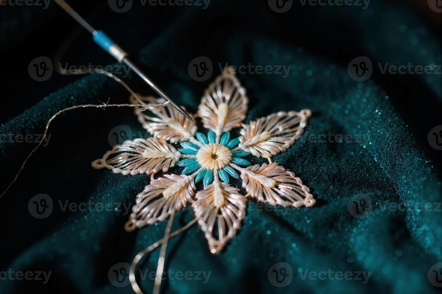 A close up of a snowflake on a green cloth photo
