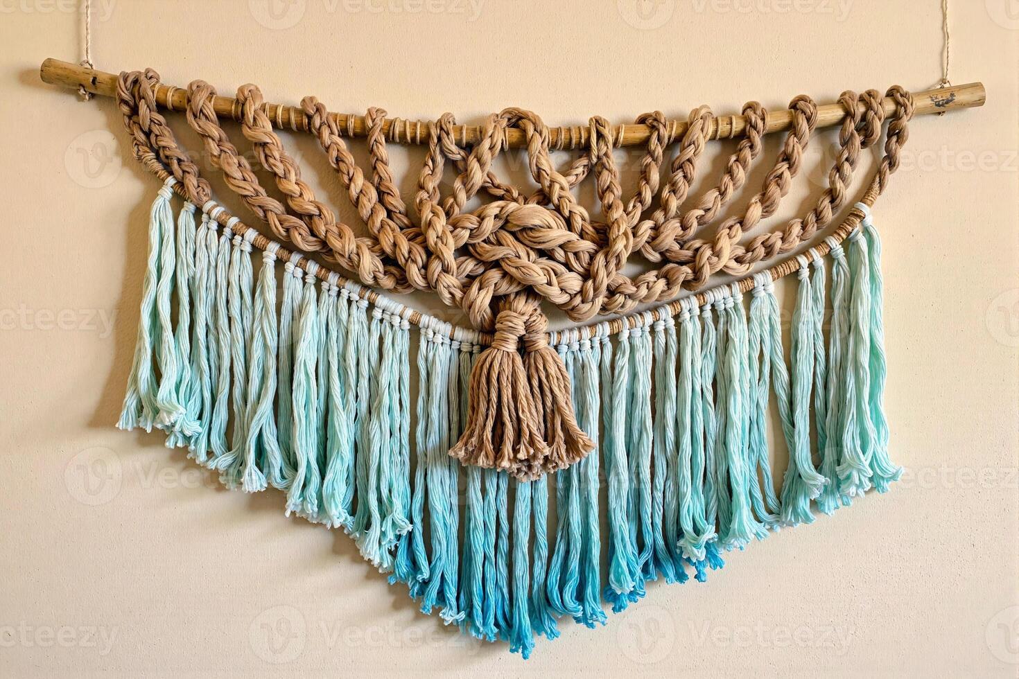 A blue and brown macrame wall hanging with tassels photo