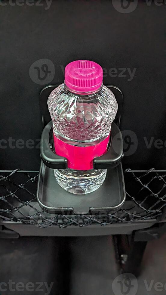Mineral water in the seat cup holder symbolizes comfort and safety during the journey. photo