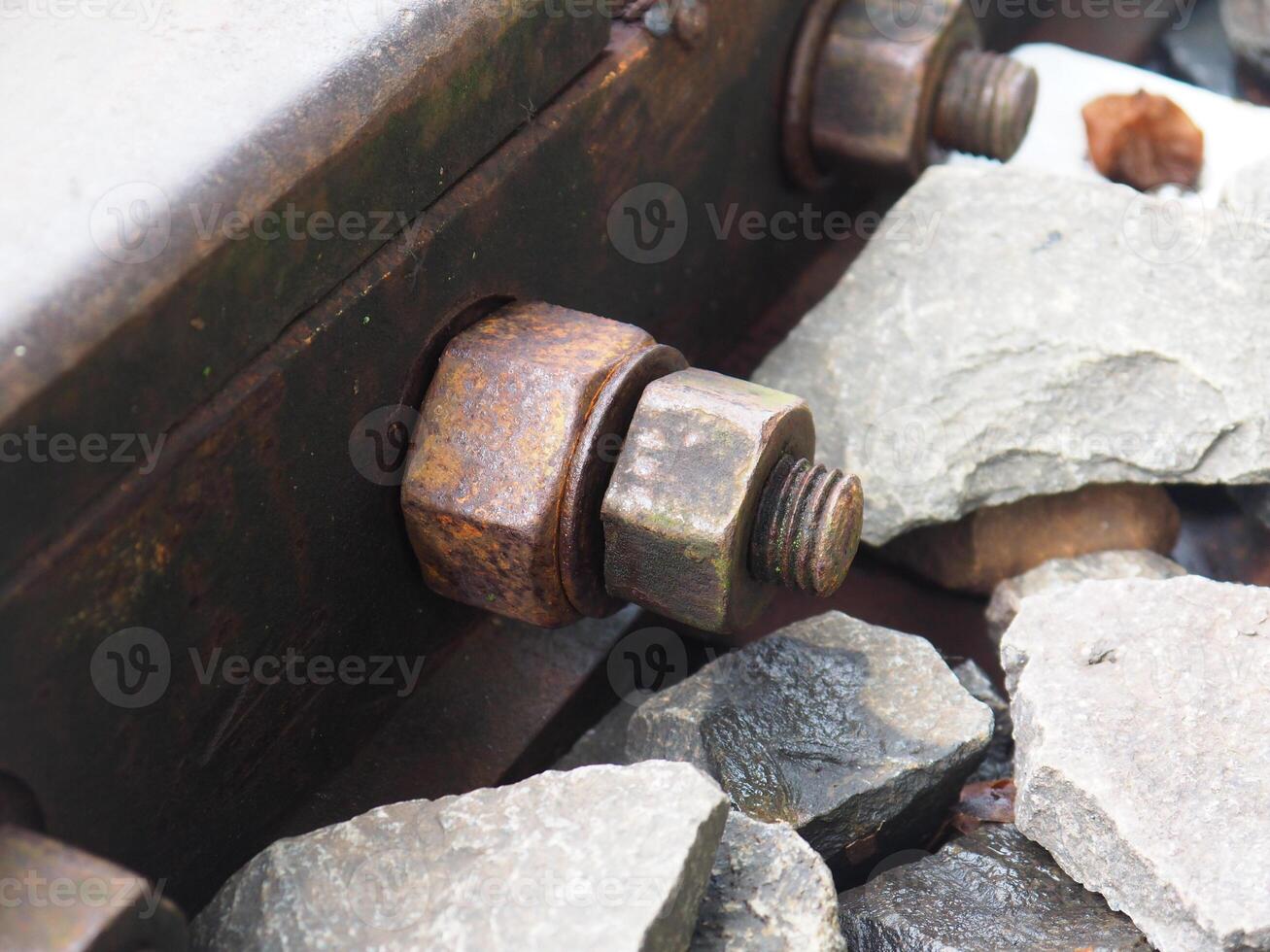 A detailed view showing rusty railroad tracks with a mossy texture, showing the texture fading with age, symbolizing neglect and the unique beauty in the transition of materials. photo