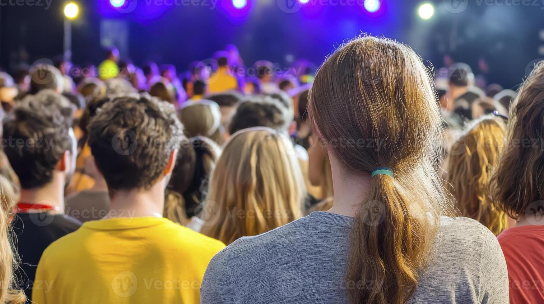 Crowd at a Concert with Bright Stage Lights and Colorful Environment in an Entertaining Atmosphere photo