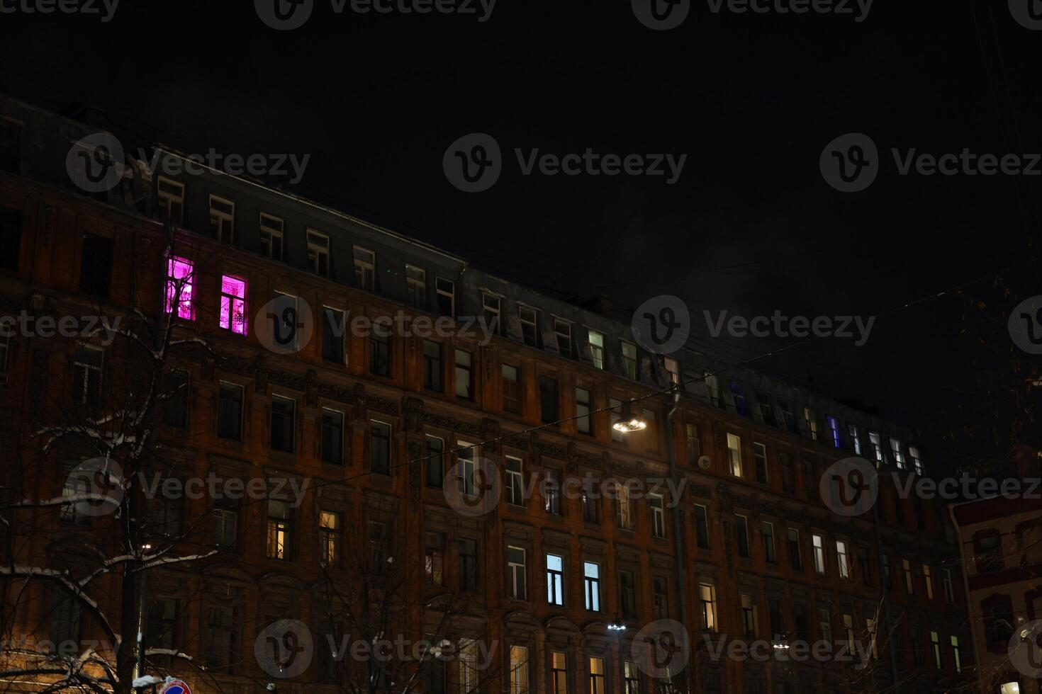 A stunning and captivating night view of a historic building adorned with colorful windows photo
