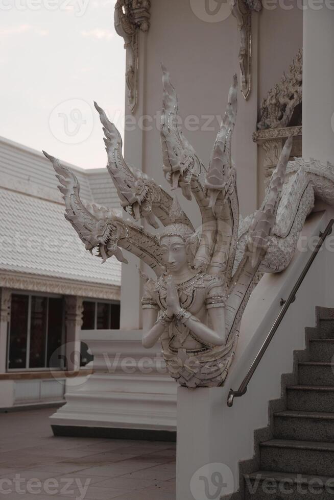 The Intricate and Exquisite Sculpture of a Deity at the Wat Rong Khun Temple in Thailand photo