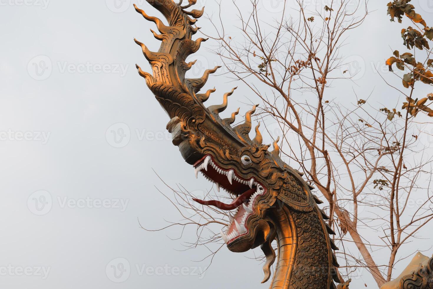 A Majestic Naga Statue That Stands Proudly Against the Majestic Backdrop of the Sky photo