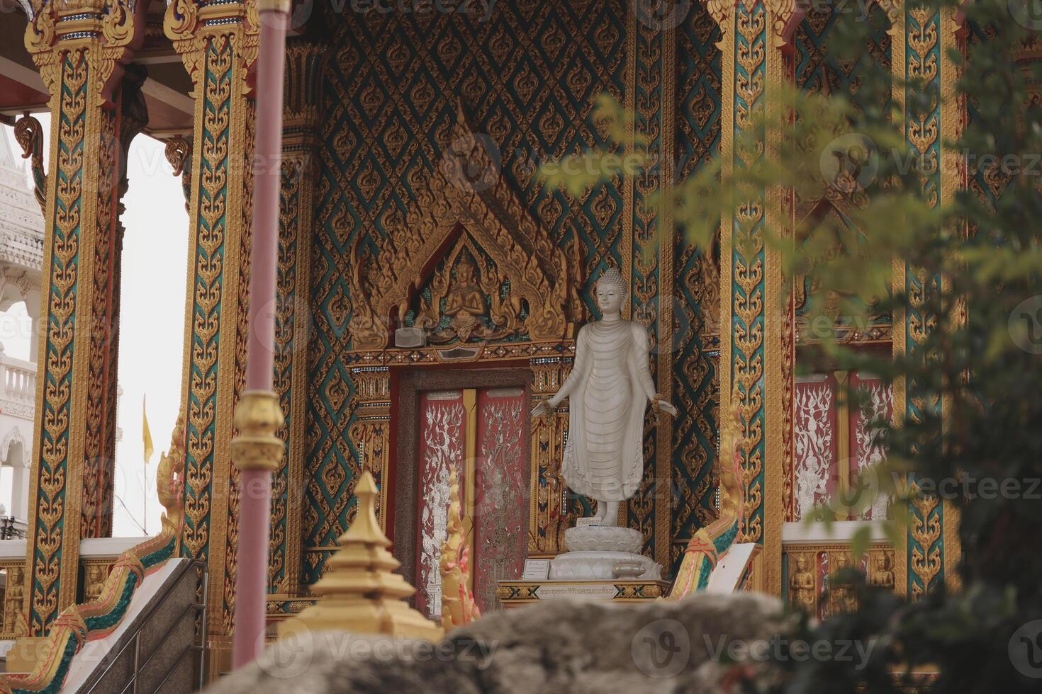 A beautiful Buddha statue in an ornate temple radiates tranquility, inviting reflection photo