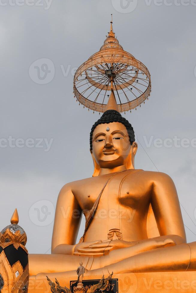 The Golden Buddha Statue is majestically positioned under a clear, blue sky, captivating all photo