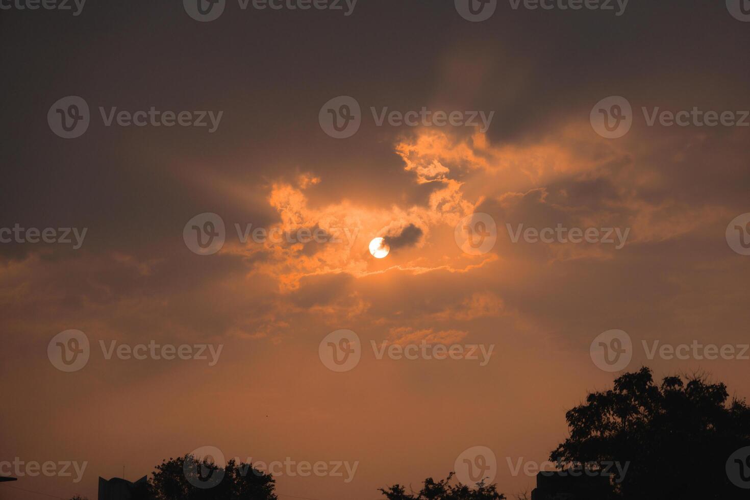 Dramatic and Mesmerizing Sunset Through Clouds with Rays of Light Illuminating the Sky photo
