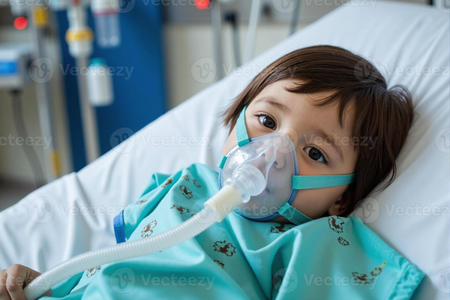 A young child in a hospital bed with an oxygen mask photo