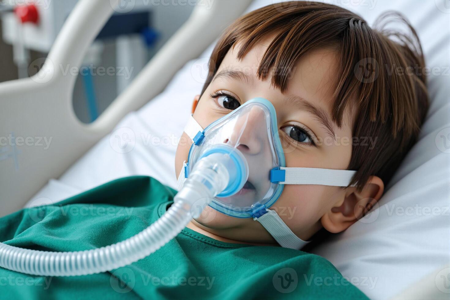 A young boy with an oxygen mask on his face photo
