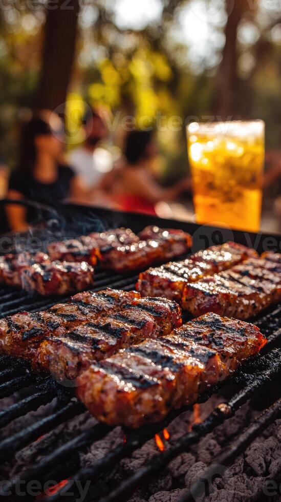 Juicy steaks sizzle on a grill in a vibrant outdoor setting. Friends enjoy each other's company while sipping refreshing drinks under the warm sunlight photo