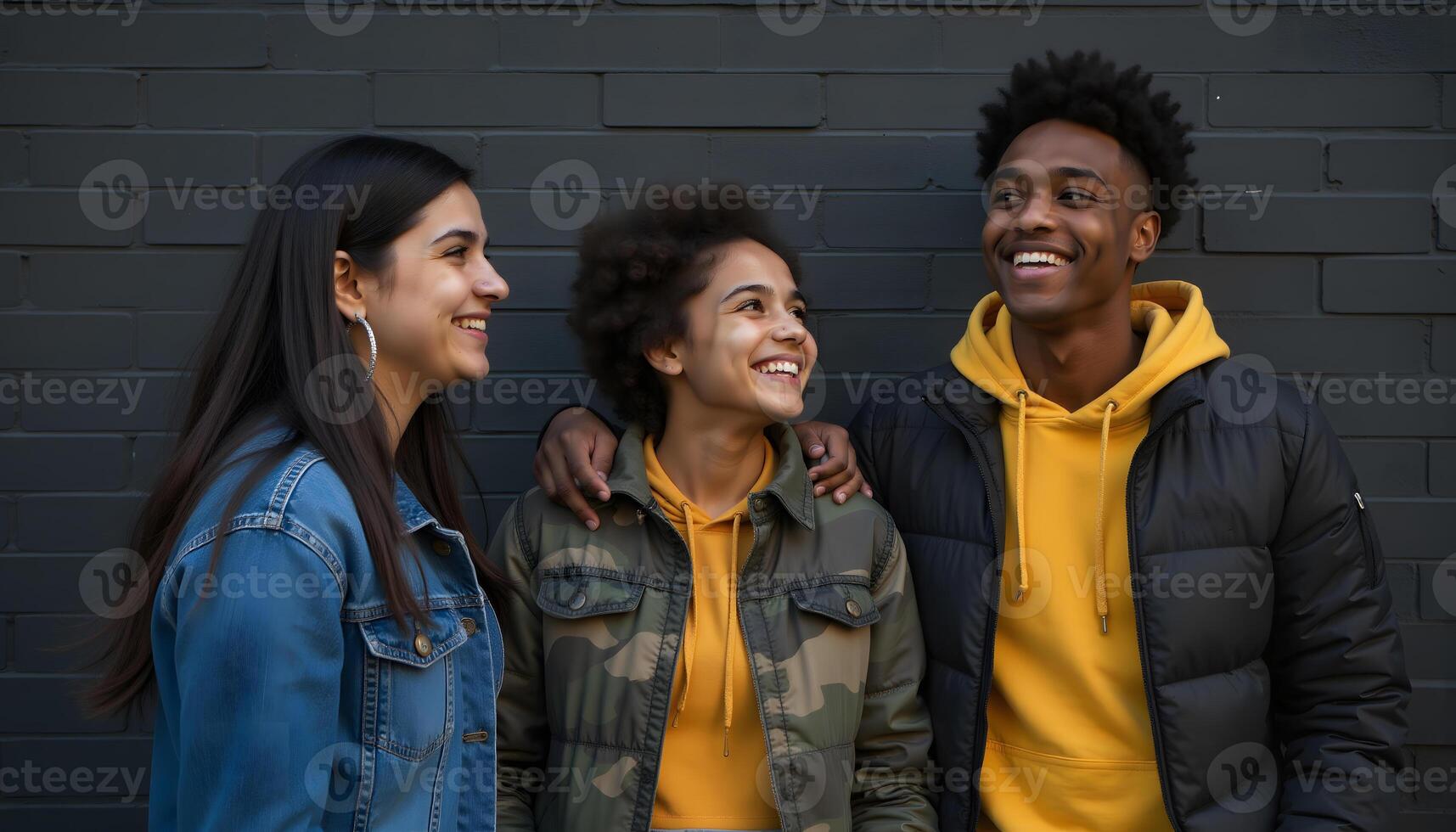 Gen Z Friends Smiling Together Against Brick Wall photo