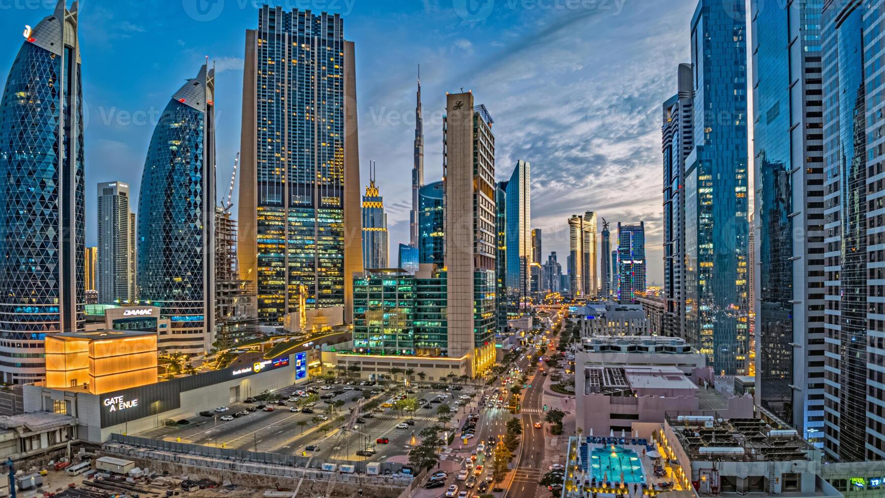 Dubai business district with modern skyscrapers, Burj Khalifa, and highrise buildings at dusk 2 photo