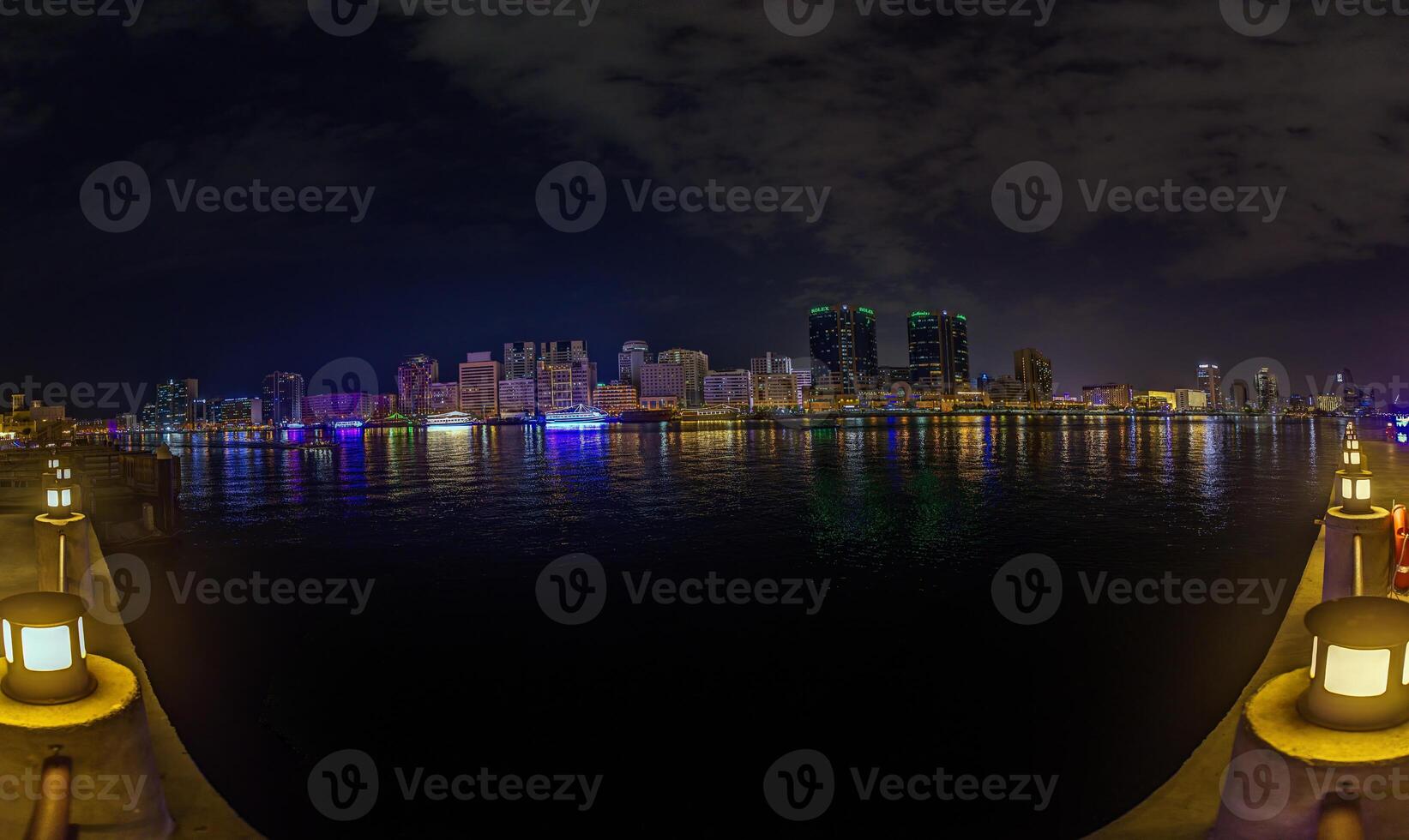 Dubai Creek at night with a stunning skyline, illuminated buildings, and shimmering reflections photo