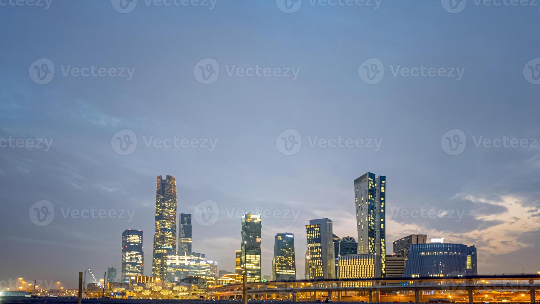 Illuminated skyline of King Abdullah Financial District in Riyadh at night with modern skyscrapers photo