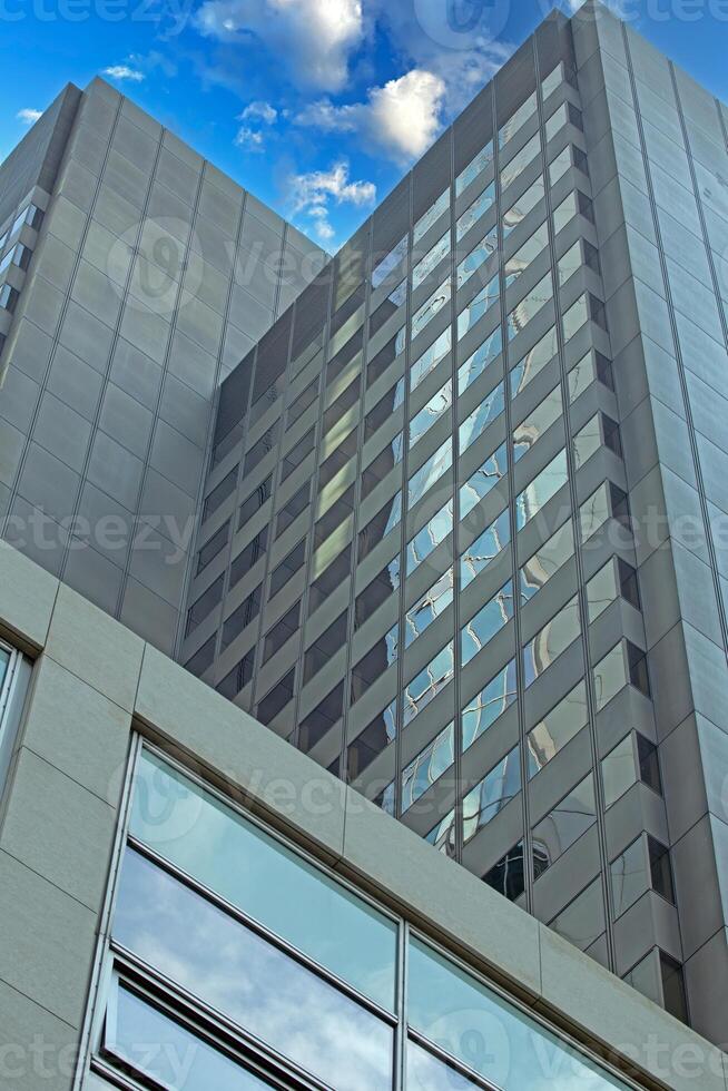 Close up of modern glass facade reflecting blue sky in Frankfurt 1 photo