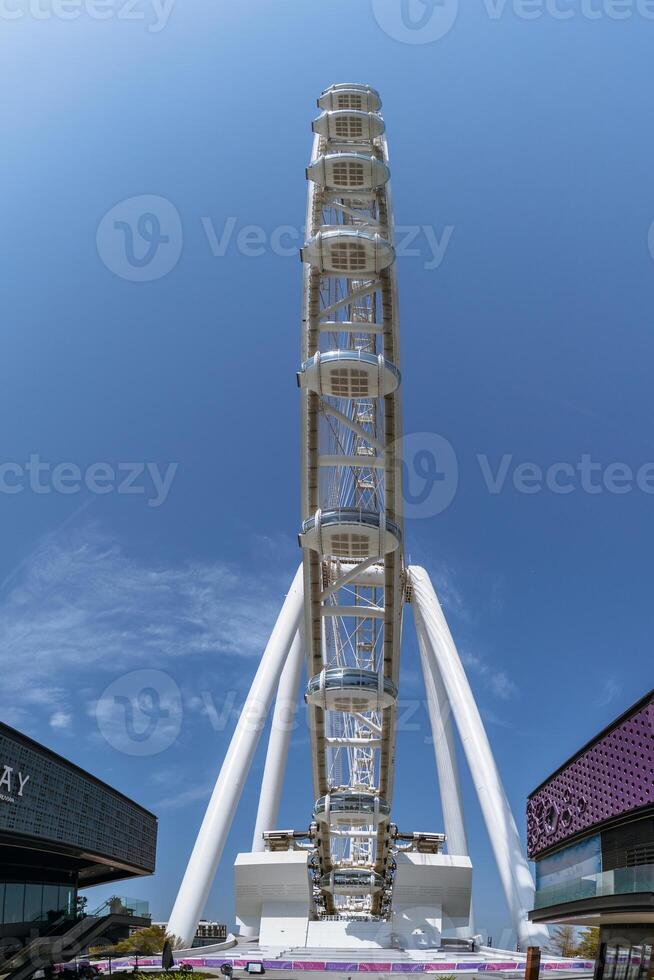 Dubai Marina Ferris wheel viewed from below against blue sky 4 photo